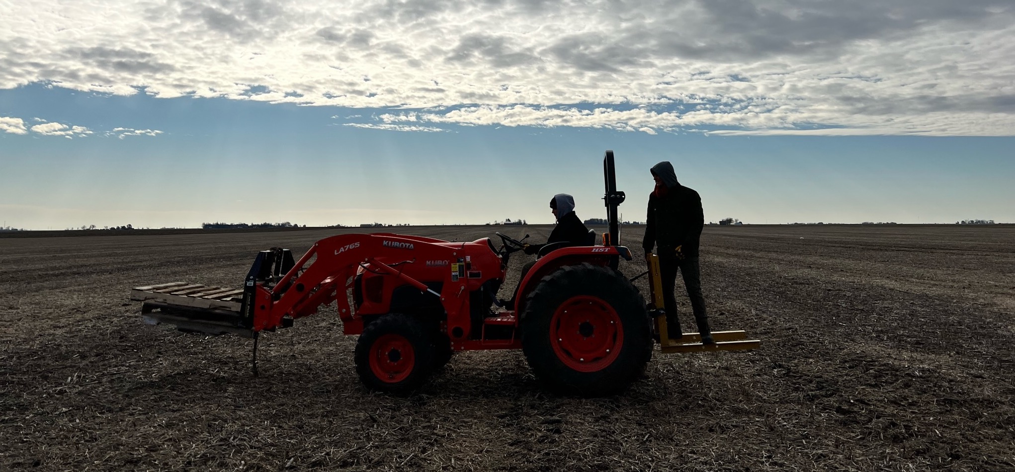 Ashton and Tess Reedy driving the tractor in the field.