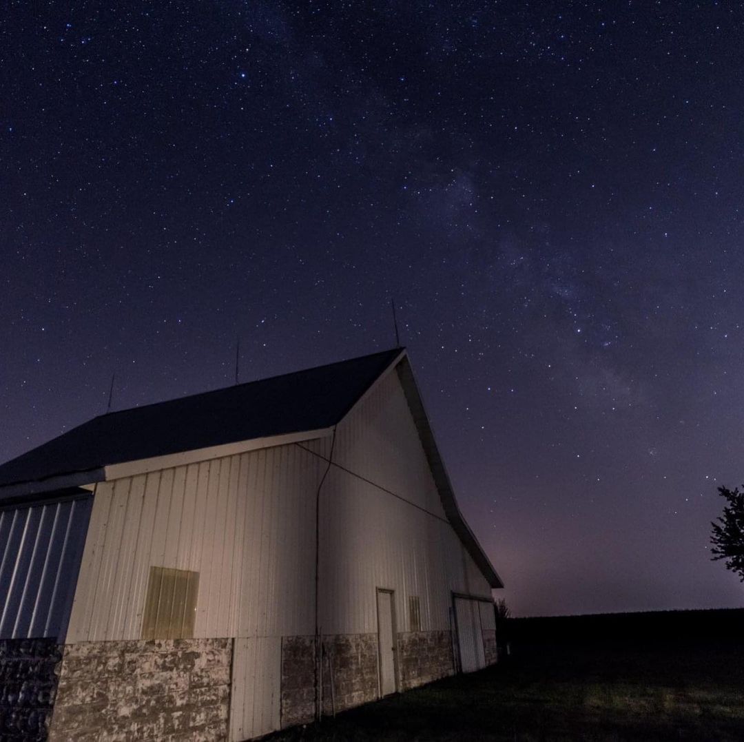 The original barn with the star filled night sky.